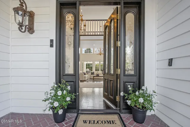 a view of front door of house and potted plant