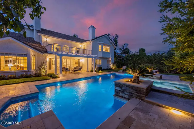 a swimming pool with outdoor seating