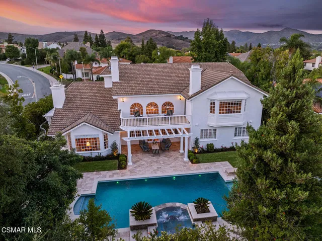 an aerial view of a house with a garden and a yard