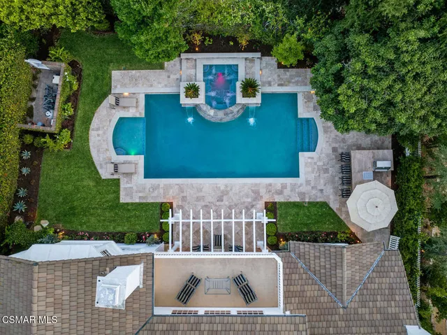 an aerial view of a house with garden space and street view