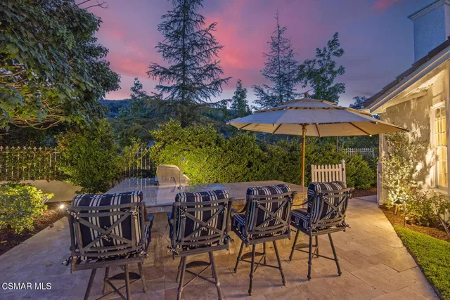 a patio with a patio table and chairs