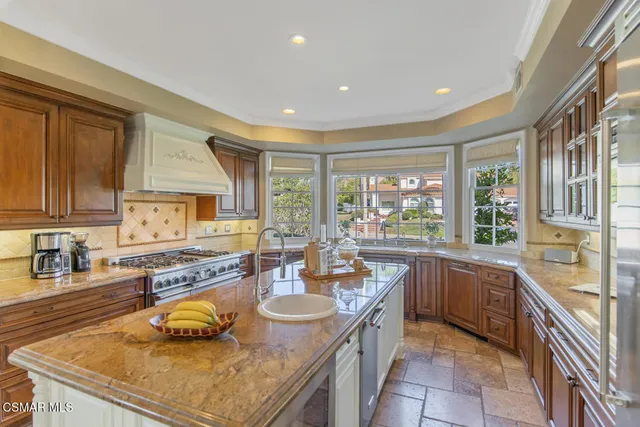 a kitchen with a stove sink and cabinets