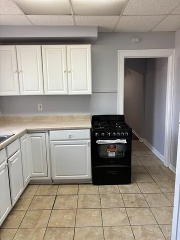 a kitchen with a stove a sink and a cabinets