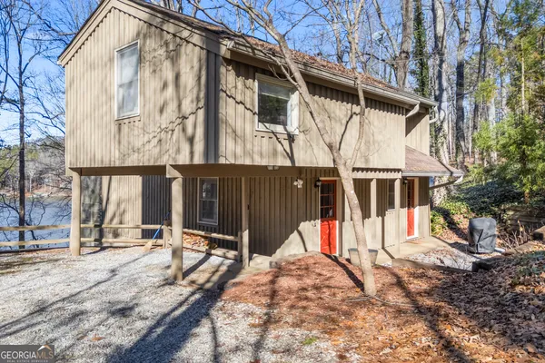 a view of a house with wooden fence