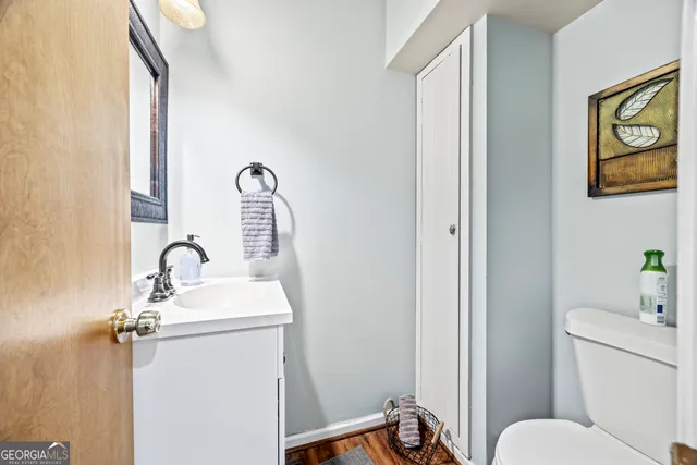 a bathroom with a toilet sink and mirror