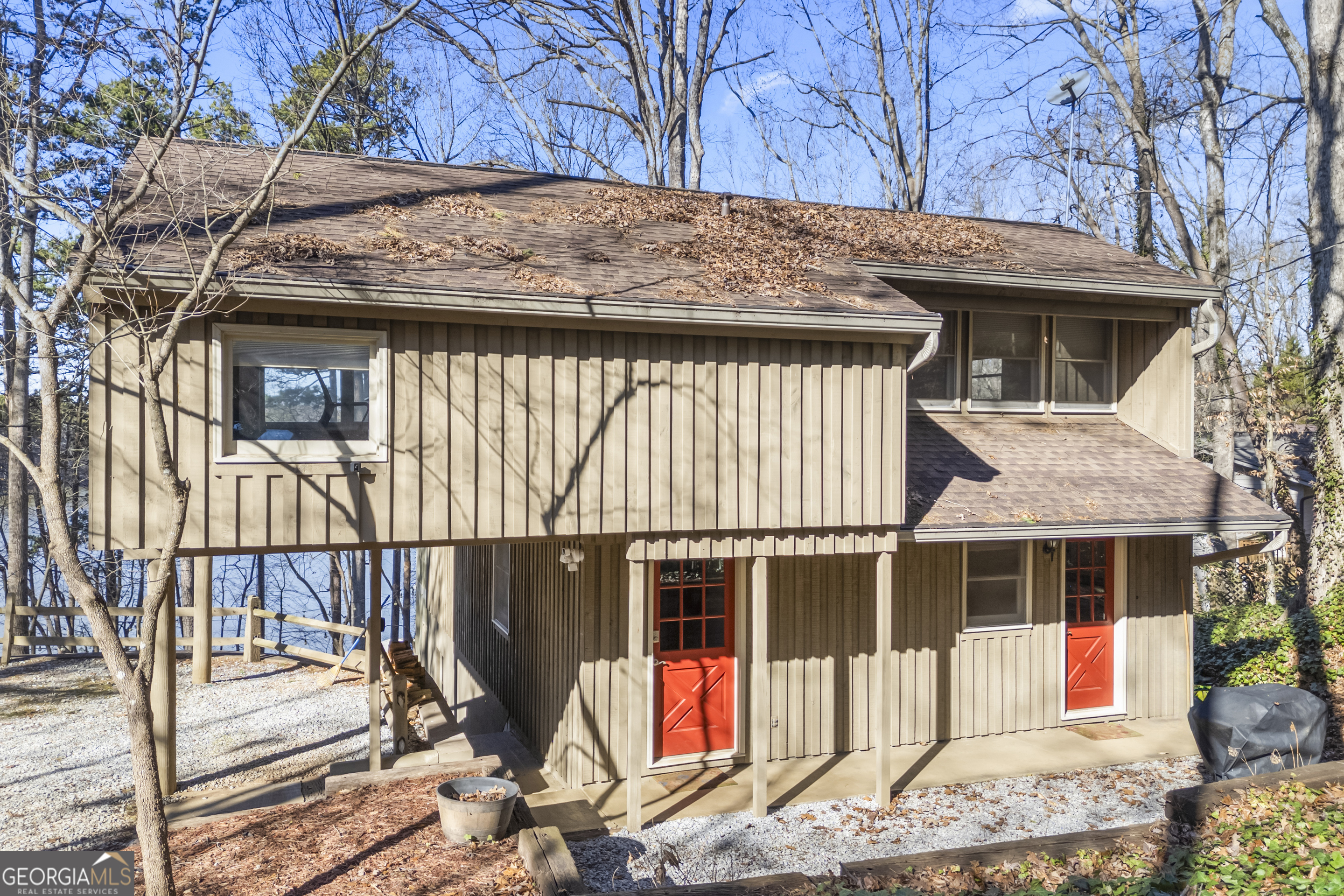 59 Waters Edge Extension Martin, GA 30557 - Photo 2 of 48 a view of a house with a wooden fence and floor to ceiling windows