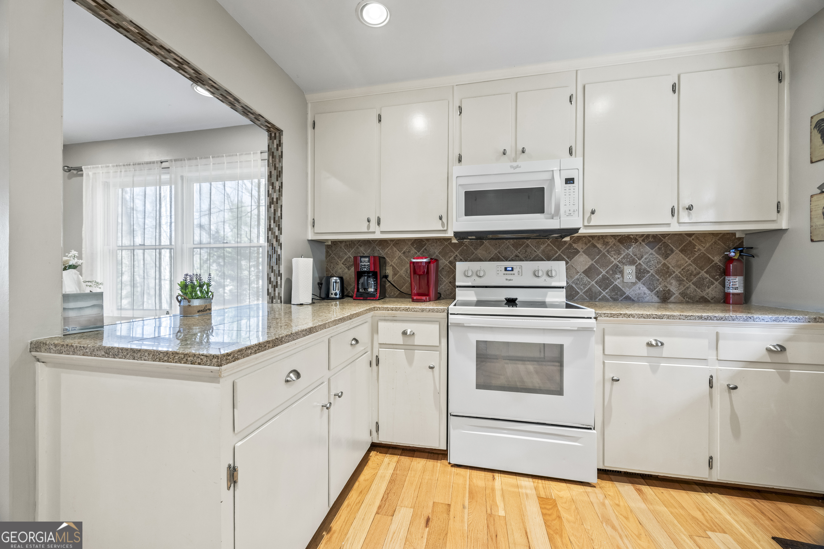 59 Waters Edge Extension Martin, GA 30557 - Photo 22 of 48 a kitchen with stainless steel appliances granite countertop a stove a sink and white cabinets