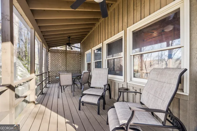 a view of a patio with table and chairs and wooden floor