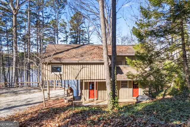 a front view of a house with a tree