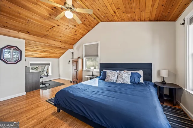 a large bed sitting in a bedroom next to a larger window
