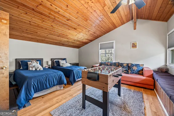 a bedroom with furniture and wooden floor