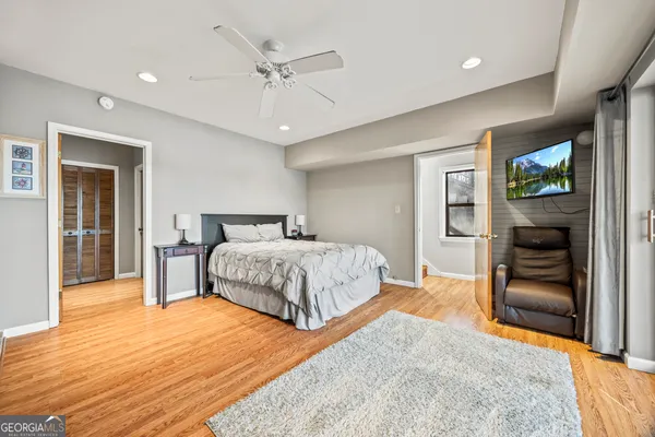 a bedroom with a bed and a television