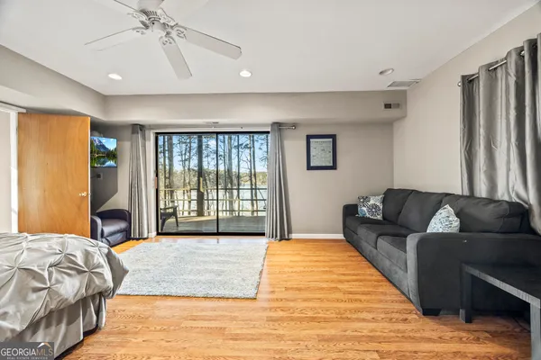 a spacious bedroom with a large bed and a chandelier