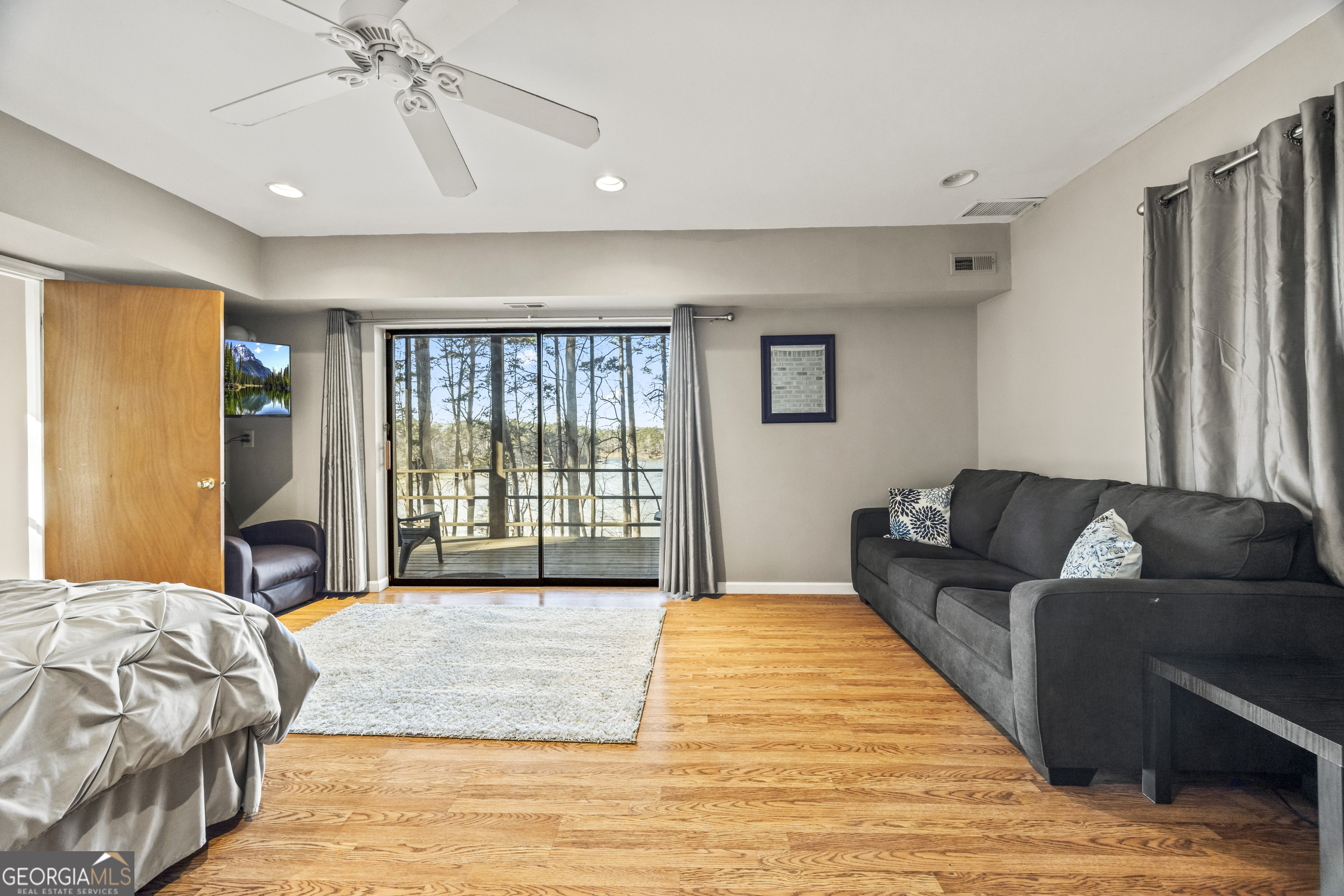 59 Waters Edge Extension Martin, GA 30557 - Photo 43 of 48 a spacious bedroom with a large bed and a chandelier