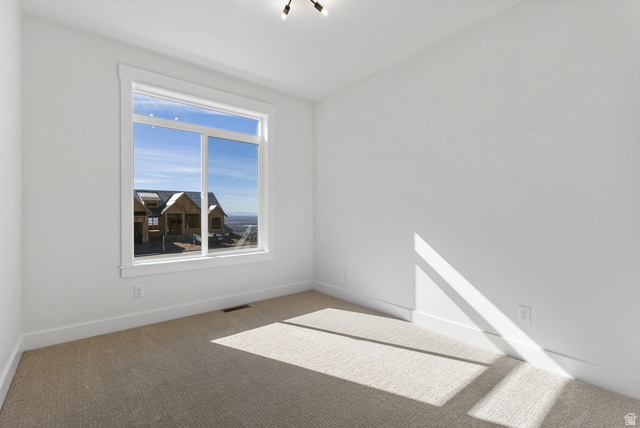 638 East Mountain Road North Ogden, UT 84414 - Photo 19 of 28 Empty room with carpet and baseboards