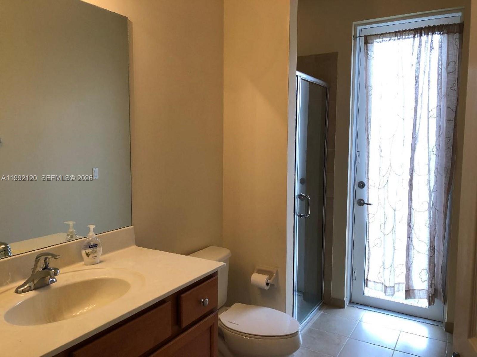 17000 Southwest 90th Terrace Miami, FL 33196 - Photo 5 of 56 a bathroom with a sink a toilet a window and vanity
