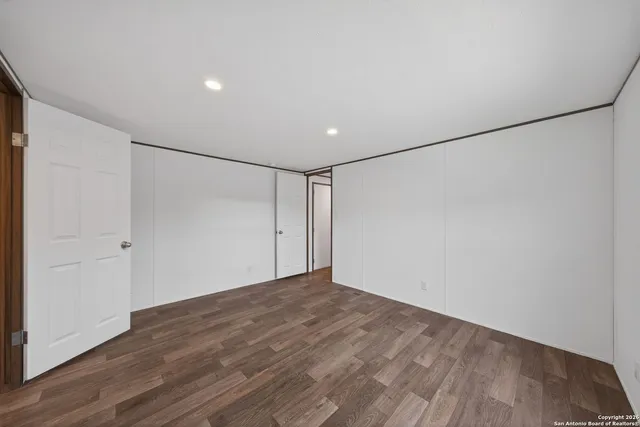 a view of a room with wooden floor