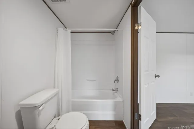 a bathroom with a toilet and a bathtub