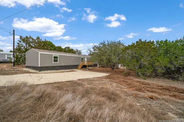 a view of a house with a yard and garage