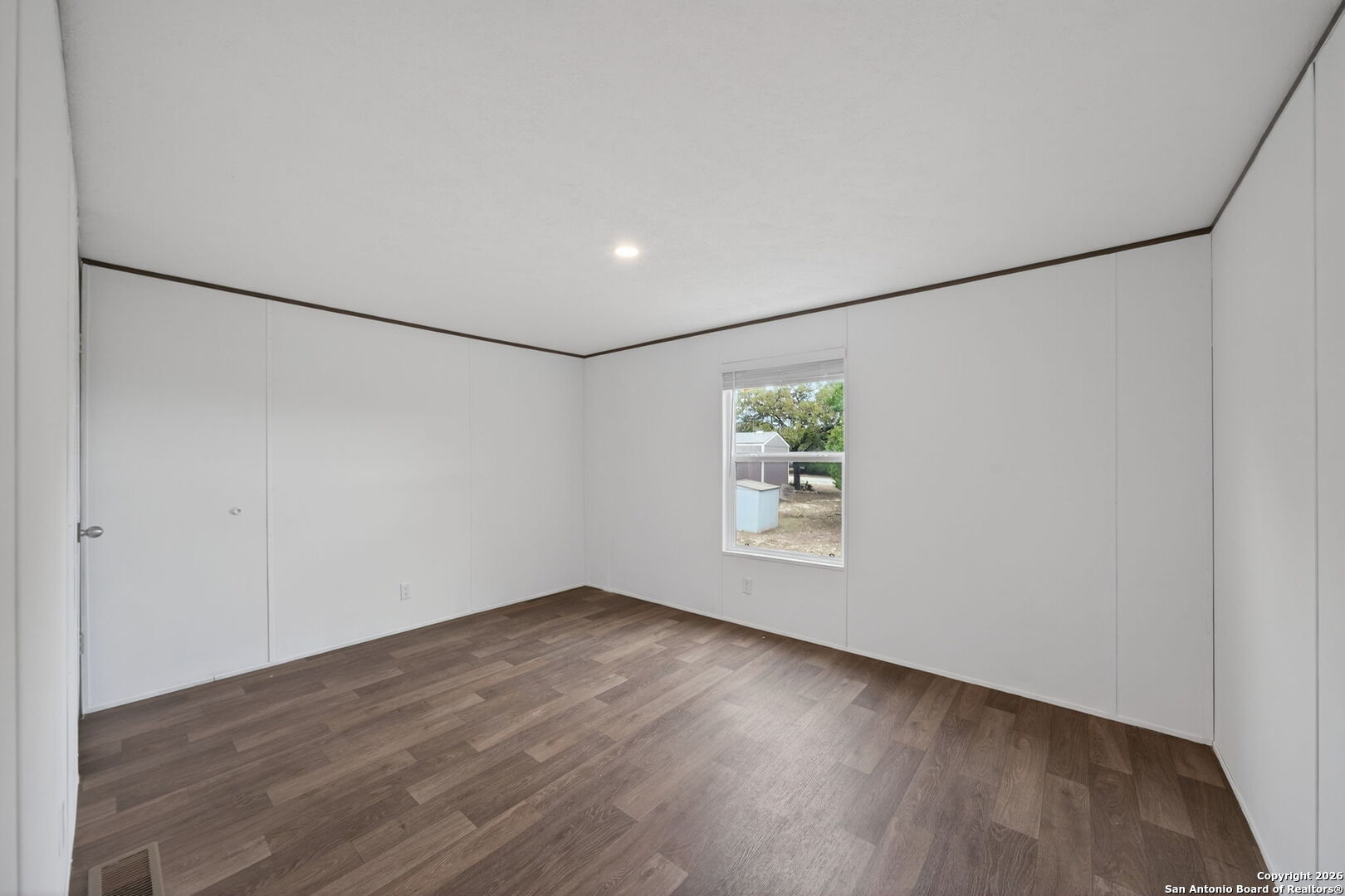 Lot 38 Pr 1510 Bandera, TX 78003 - Photo 21 of 30 a view of an empty room with wooden floor and a window