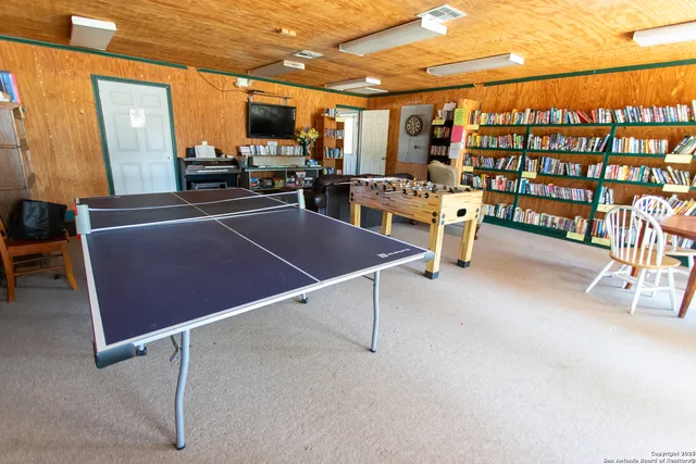 a book shelf with chairs in a room