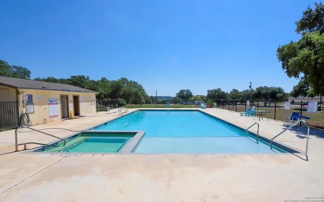 a view of swimming pool with outdoor seating