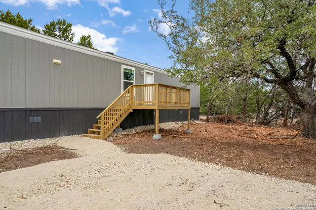 a wooden bench sitting in middle of a yard