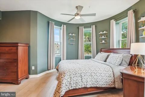 a bedroom with a large bed and a chandelier
