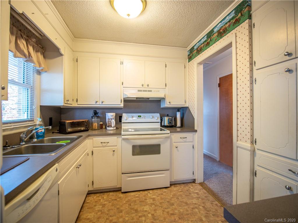 1956 Tradesville Road Lancaster, SC 29720 - Photo 12 of 18 a kitchen with a stove white cabinets sink and a window