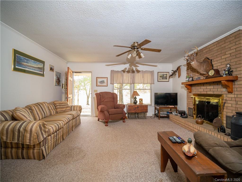1956 Tradesville Road Lancaster, SC 29720 - Photo 3 of 18 a living room with furniture ceiling fan and a fireplace
