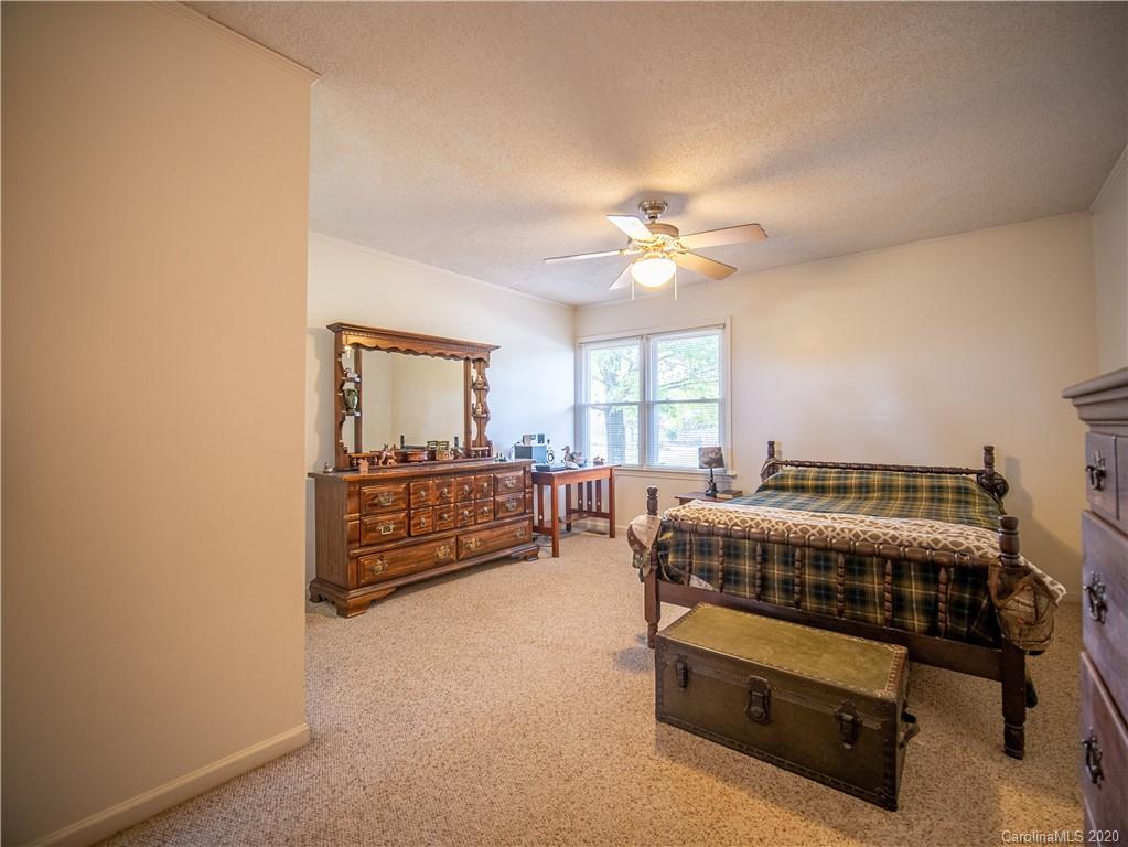 1956 Tradesville Road Lancaster, SC 29720 - Photo 9 of 18 a bedroom with furniture and a chandelier