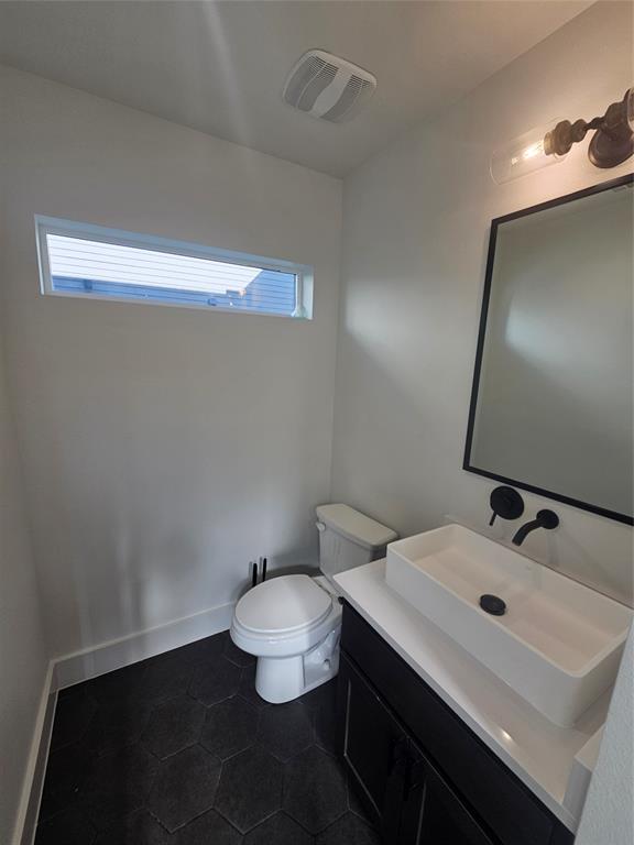 2139 Mail Avenue, Unit 101 Dallas, TX 75235 - Photo 11 of 21 a bathroom with a sink a toilet and mirror