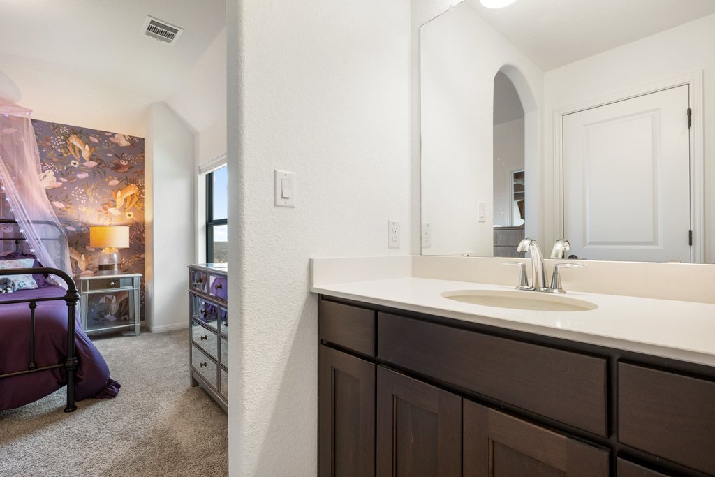 1221 Siena Sunset Road Leander, TX 78641 - Photo 28 of 39 White countertop vanity with an integrated sink and chrome faucet