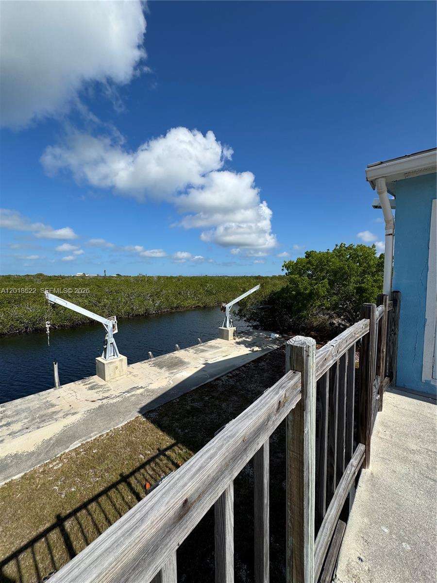 a view of a balcony with wooden floor and fence
