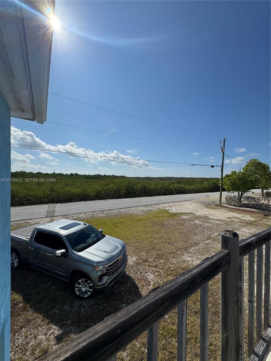 4276 Dorn Road Summerland Key, FL 33042 - Photo 4 of 23 a view of a balcony with chair and wooden floor