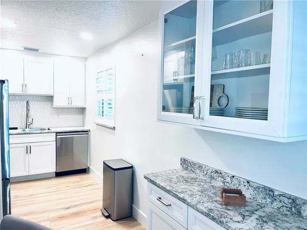 a kitchen with a sink cabinets and window