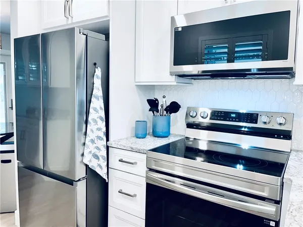 a kitchen with appliances and cabinets