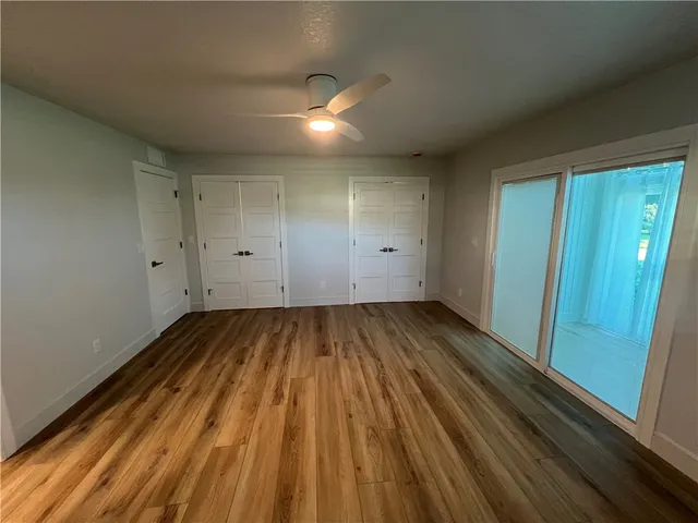 a view of a room with wooden floor