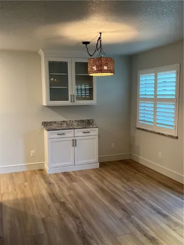 a view of a kitchen with a sink cabinets and wooden floor