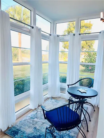 a view of a dining room with furniture window and outside view