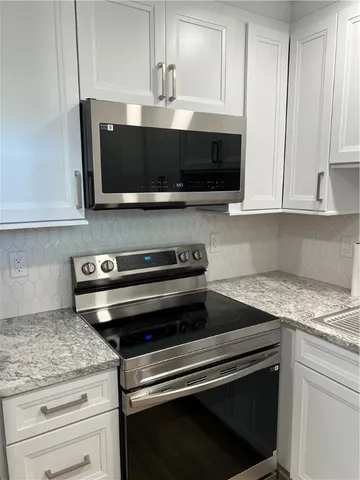 a kitchen with stainless steel appliances a sink and a microwave