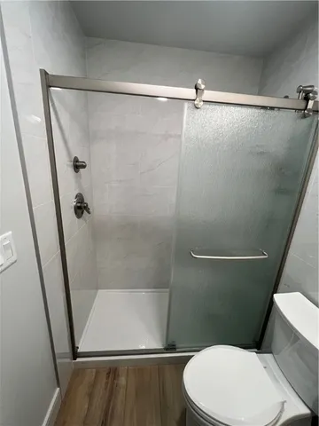 a bathroom with a toilet and a shower