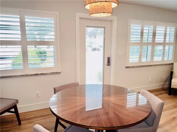 a view of a dining room with furniture window and wooden floor