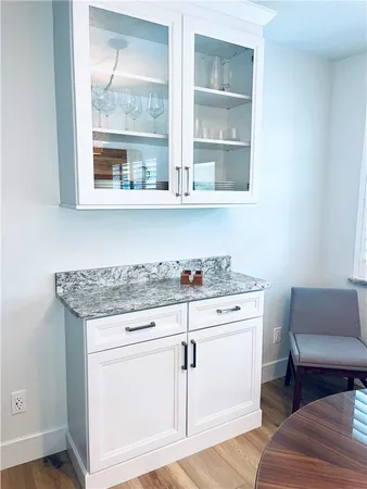 a view of cabinets with wooden floor and a window