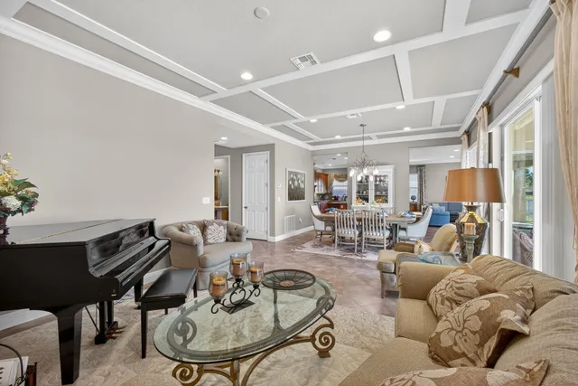 a large kitchen with kitchen island granite countertop a stove top oven a sink a dining table and chairs with wooden floor