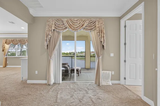 an aerial view of lake and residential houses with outdoor space
