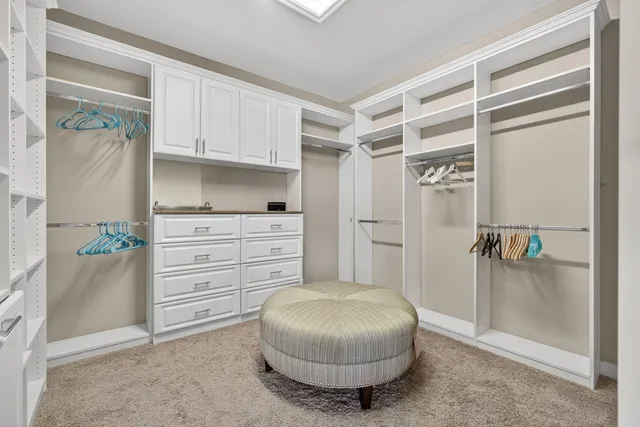a view of a house with a yard and potted plants