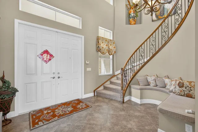 a view of a dining room with furniture large window and chandelier