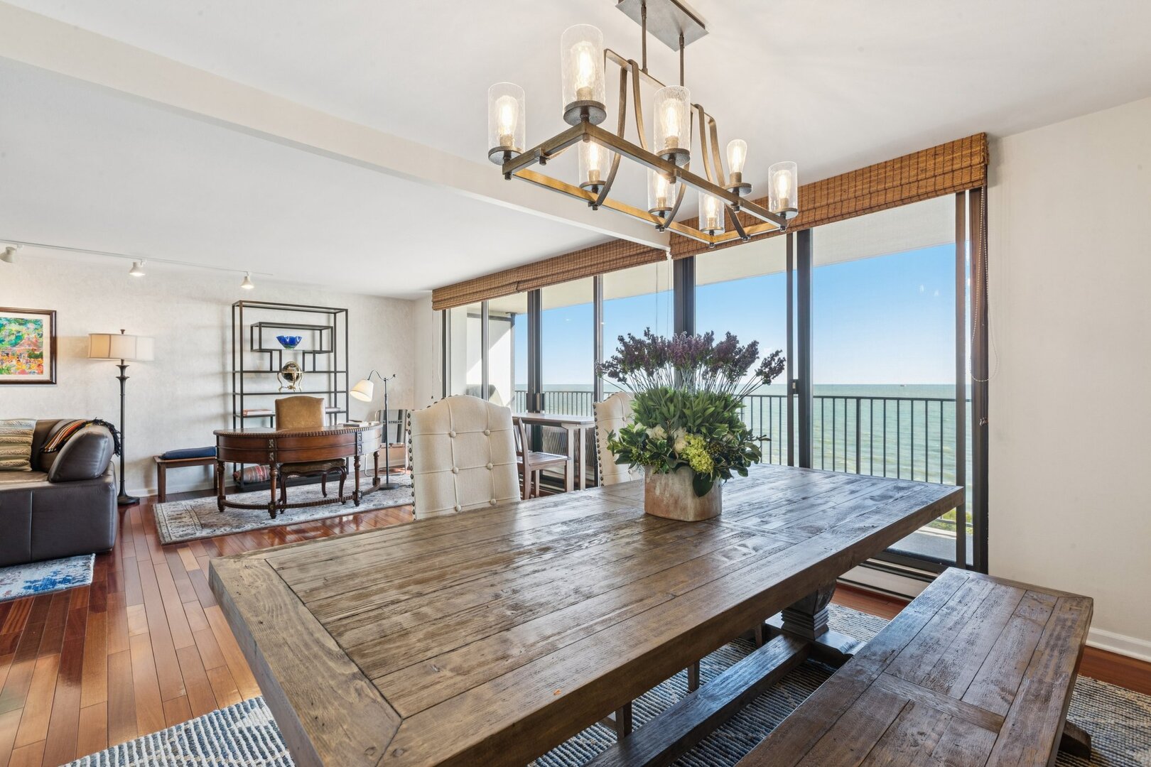 1212 North Lake Shore Drive, Unit 10CS Chicago, IL 60610 - Photo 15 of 65 a dining room with wooden floor a chandelier a wooden table and chairs