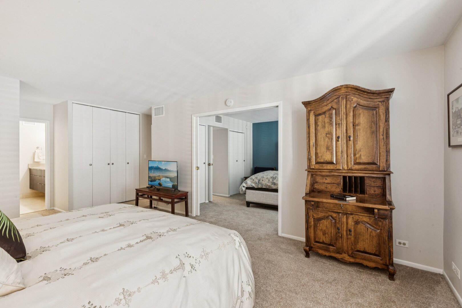 1212 North Lake Shore Drive, Unit 10CS Chicago, IL 60610 - Photo 30 of 65 a bedroom with a bed and dresser with mirror